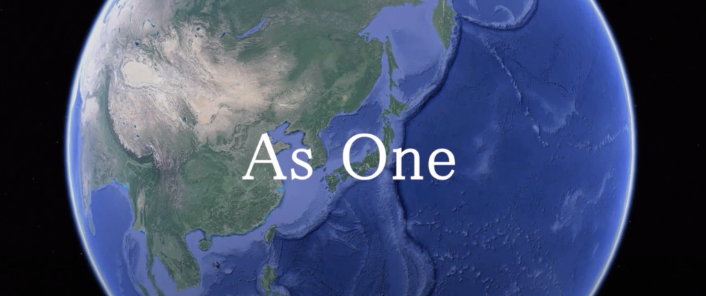 Erdkugel aus der Weltall-Perspektive vor der in weiss steht: "As One"